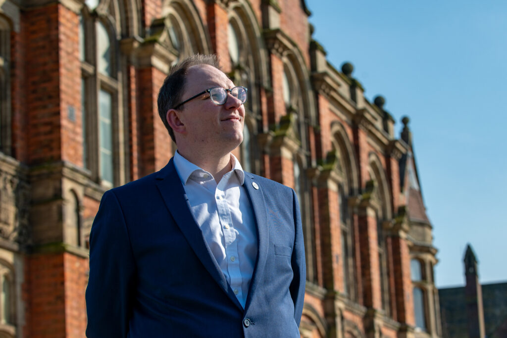 Gareth Snell MP stood outside of a building looking up
