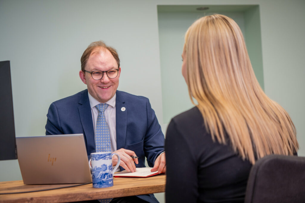 Gareth Snell MP sat at his desk speaking to a member of the public